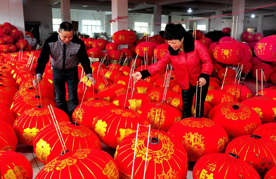 12月18日,浙江省武义县甫上村的来料加工户在撑晾刚制作完成的红灯 