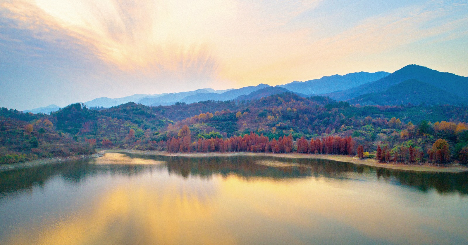 昨日,记者在麻堰水库看到,远处彤云出岫,群山叠彩,近处水面上倒映着岸